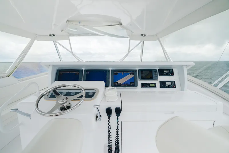 Water's Edge Yacht Photos Pics 2005 Hatteras Convertible 60 yacht helm with navigation equipment and ocean view.