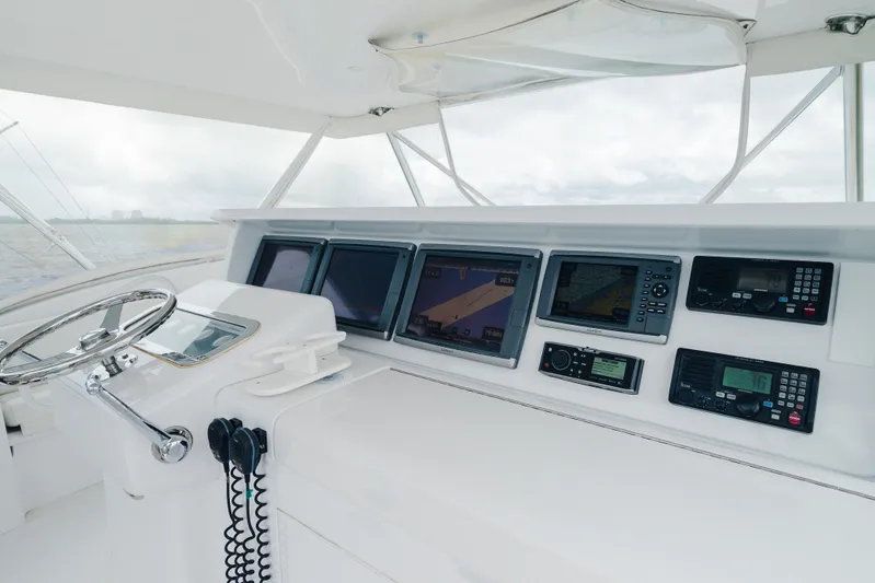 Water's Edge Yacht Photos Pics Helm of 2005 Hatteras Convertible 60 yacht with advanced navigation systems.