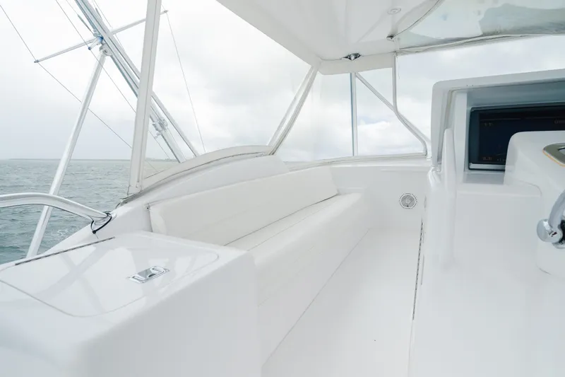 Water's Edge Yacht Photos Pics 2005 Hatteras Convertible 60 yacht interior with white seating and ocean view.