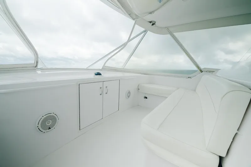 Water's Edge Yacht Photos Pics 2005 Hatteras Convertible 60 yacht interior with white seating and storage cabinets.