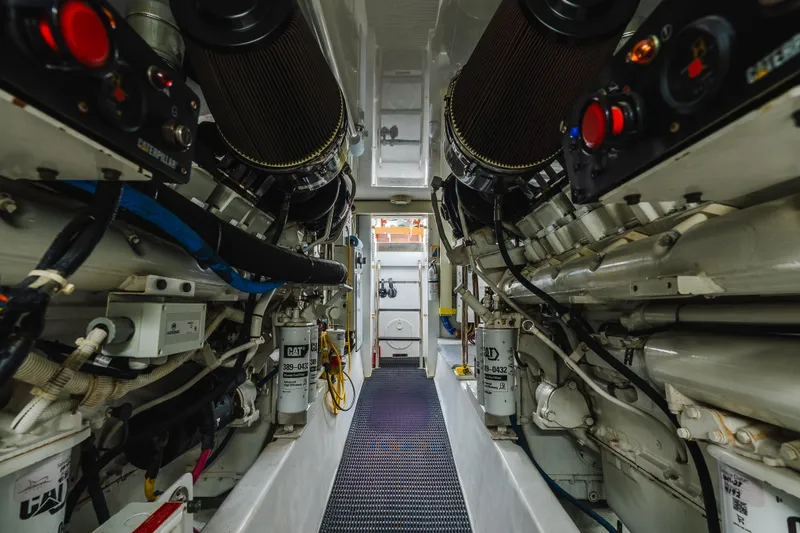 Water's Edge Yacht Photos Pics Engine room of 2005 Hatteras Convertible 60 yacht, showcasing mechanical components and systems.