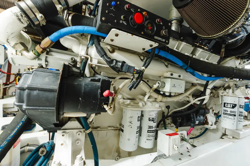 Water's Edge Yacht Photos Pics Engine room of a 2005 Hatteras Convertible 60 yacht, featuring Caterpillar components.