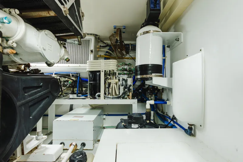 Water's Edge Yacht Photos Pics Engine room of 2005 Hatteras Convertible 60 yacht, showcasing mechanical components and systems.