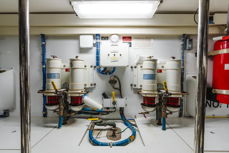 Water's Edge Yacht Photos Pics Engine room of 2005 Hatteras Convertible 60 yacht with fuel filters and control panel.