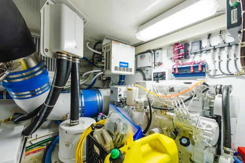 Water's Edge Yacht Photos Pics Engine room of 2005 Hatteras Convertible 60 yacht, showcasing mechanical components and wiring.