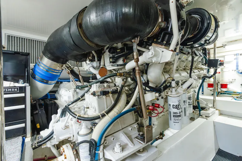 Water's Edge Yacht Photos Pics Engine room of 2005 Hatteras Convertible 60 yacht, showcasing complex machinery and components.