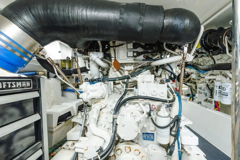 Water's Edge Yacht Photos Pics Engine room of 2005 Hatteras Convertible 60 yacht, showcasing complex machinery and components.