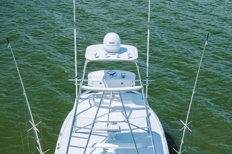 Water's Edge Yacht Photos Pics 2005 Hatteras Convertible 60 yacht, aerial view, on green water.