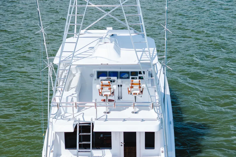 Water's Edge Yacht Photos Pics 2005 Hatteras Convertible 60 yacht with flybridge on open water.