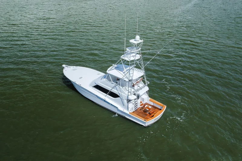 Water's Edge Yacht Photos Pics 2005 Hatteras Convertible 60 yacht on open water, aerial view.