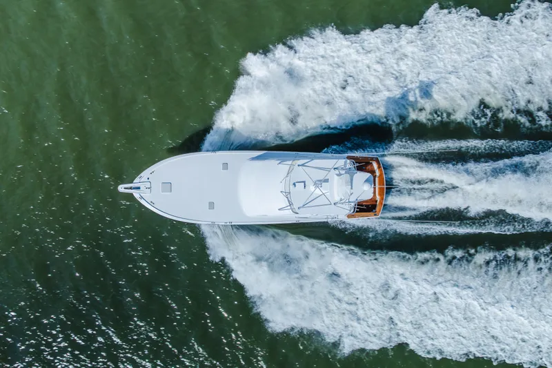 Water's Edge Yacht Photos Pics Aerial view of 2005 Hatteras Convertible 60 yacht cruising on water.