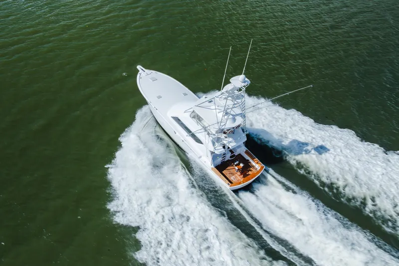 Water's Edge Yacht Photos Pics Aerial view of 2005 Hatteras Convertible 60 yacht cruising on open water.