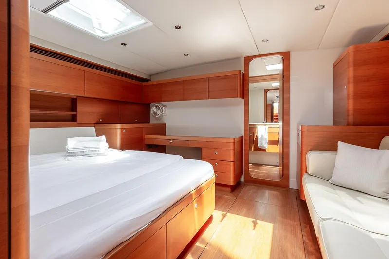 Caiarossa Yacht Photos Pics Luxurious Shipman 72 yacht interior, featuring a spacious bedroom with wooden furnishings, 2009 model.