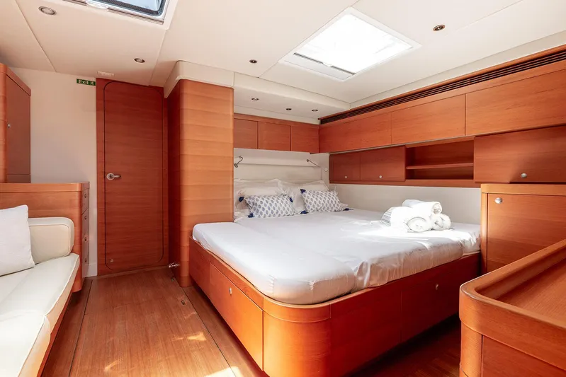Caiarossa Yacht Photos Pics Luxurious cabin interior of 2009 Shipman 72 yacht with wooden furnishings and cozy bed.