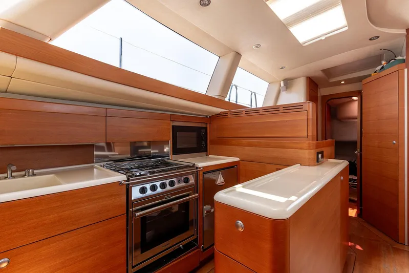 Caiarossa Yacht Photos Pics Luxurious Shipman 72 yacht kitchen interior with modern appliances, wood cabinetry, and ample natural light.