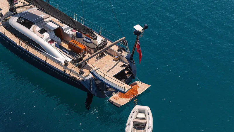 Caiarossa Yacht Photos Pics Luxurious 2009 Shipman 72 yacht with deck and tender on clear blue water.