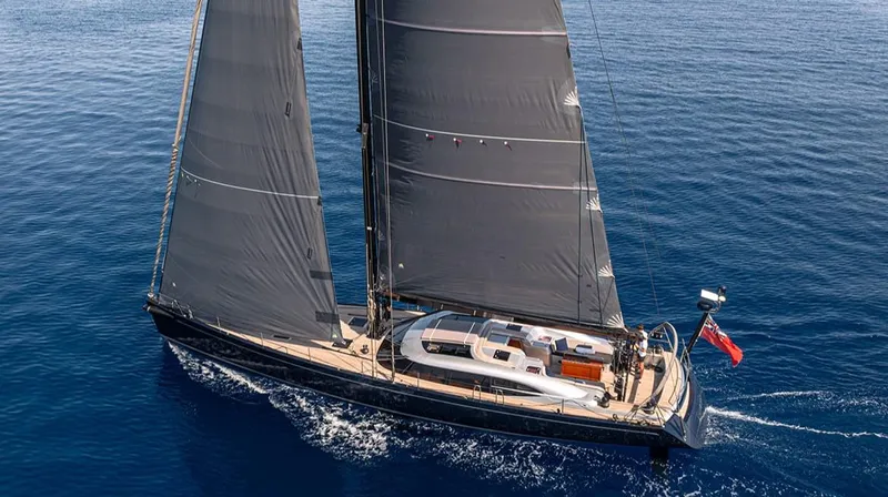 Caiarossa Yacht Photos Pics Sailing yacht Shipman 72, 2009 model, gliding on open sea with sleek black sails.
