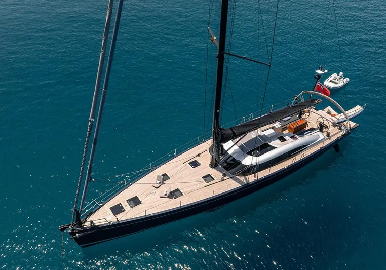 Caiarossa Yacht Photos Pics Luxurious 2009 Shipman 72 yacht sailing on clear blue waters, aerial view.