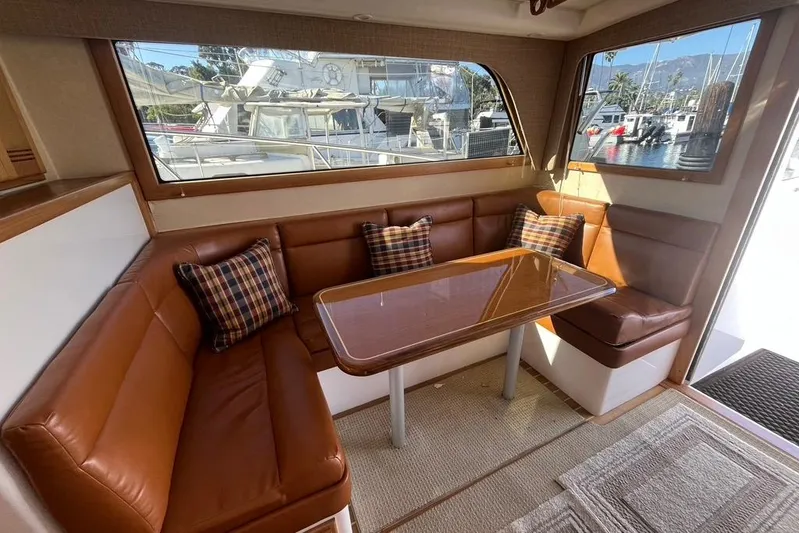 Assalt Weapon Yacht Photos Pics Interior of 2007 Cabo 35 Flybridge with leather seating and plaid cushions.