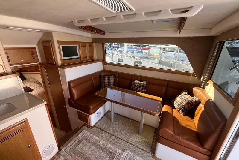 Assalt Weapon Yacht Photos Pics Interior of 2007 Cabo 35 Flybridge yacht with leather seating and dining area.