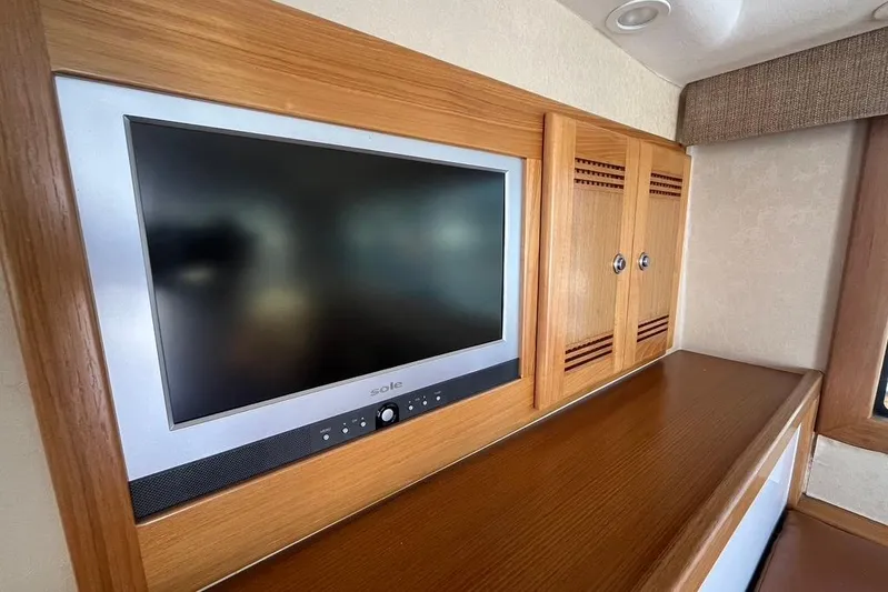 Assalt Weapon Yacht Photos Pics Flat-screen TV and wooden cabinets inside a 2007 Cabo 35 Flybridge yacht.