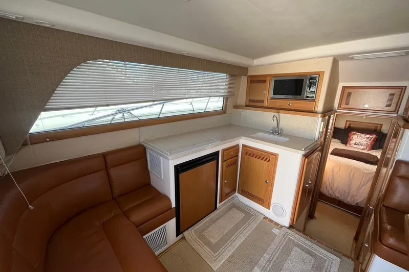 Assalt Weapon Yacht Photos Pics Luxurious interior of 2007 Cabo 35 Flybridge yacht with kitchen and seating area.