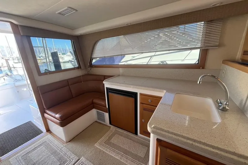 Assalt Weapon Yacht Photos Pics Interior of 2007 Cabo 35 Flybridge yacht with seating, kitchenette, and marina view.