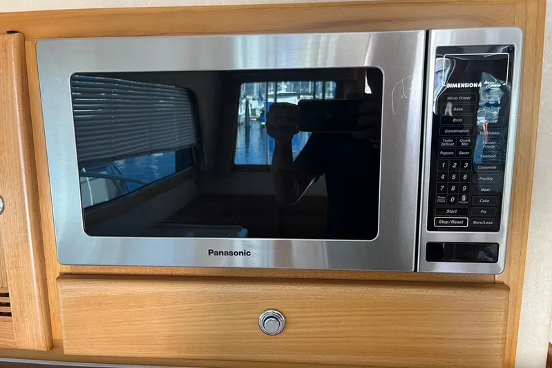 Assalt Weapon Yacht Photos Pics Panasonic microwave in 2007 Cabo 35 Flybridge kitchen, wooden cabinetry.