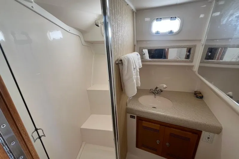 Assalt Weapon Yacht Photos Pics 2007 Cabo 35 Flybridge bathroom with shower, sink, and mirror.