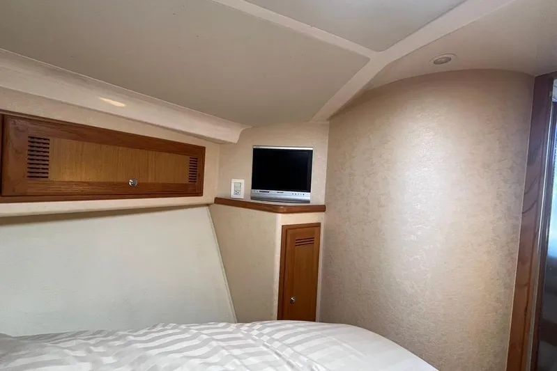 Assalt Weapon Yacht Photos Pics Interior of 2007 Cabo 35 Flybridge with TV and wooden cabinetry.