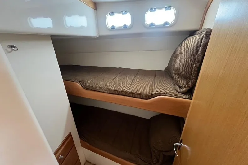 Assalt Weapon Yacht Photos Pics 2007 Cabo 35 Flybridge cabin with cozy bunk beds and porthole windows.