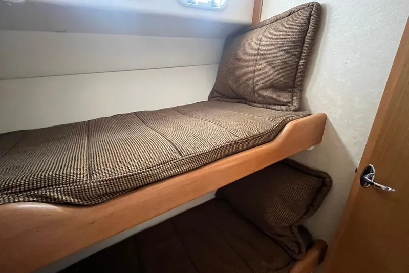 Assalt Weapon Yacht Photos Pics 2007 Cabo 35 Flybridge interior with cozy bunk beds and wooden accents.