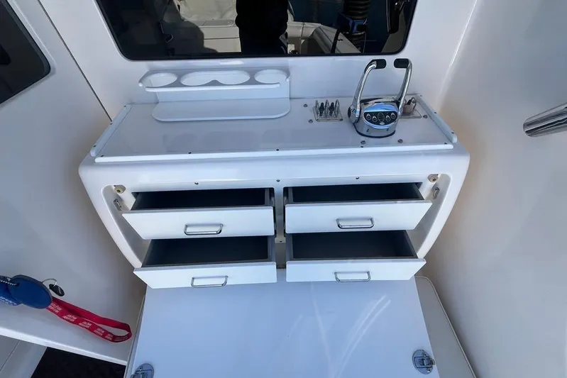 Assalt Weapon Yacht Photos Pics 2007 Cabo 35 Flybridge interior with open storage drawers and control panel.