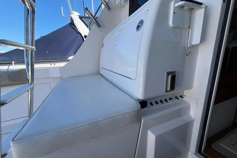 Assalt Weapon Yacht Photos Pics 2007 Cabo 35 Flybridge interior seating with control panel and ladder.