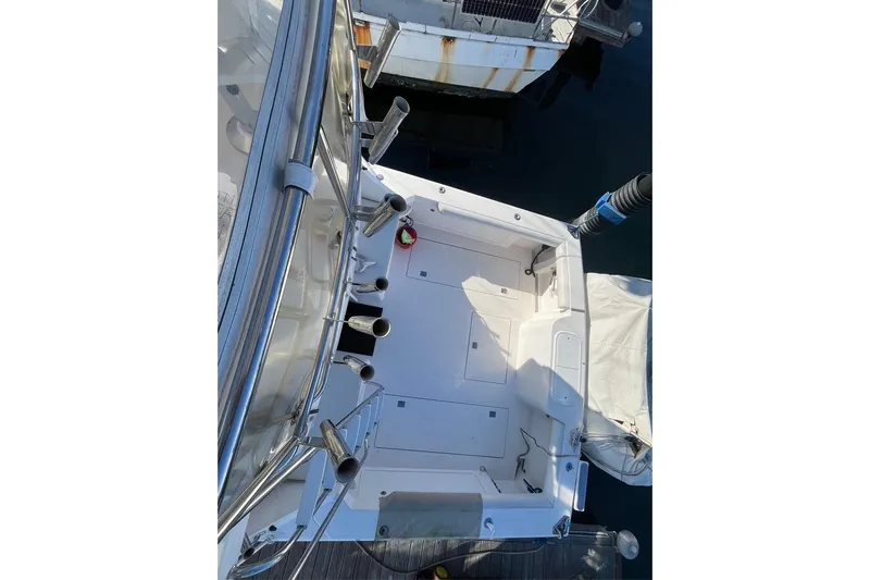 Assalt Weapon Yacht Photos Pics 2007 Cabo 35 Flybridge boat deck view, featuring fishing rod holders and clean layout.