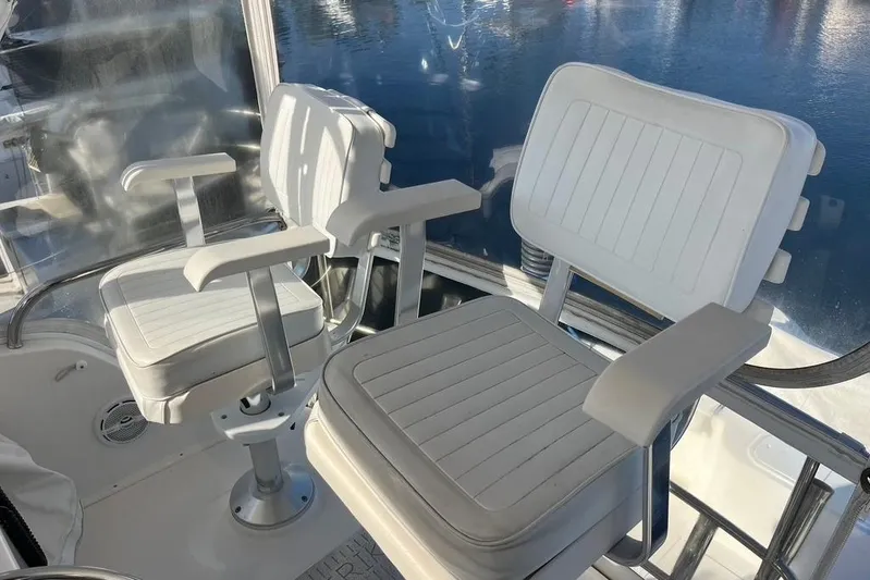 Assalt Weapon Yacht Photos Pics 2007 Cabo 35 Flybridge boat interior with two white captain chairs.