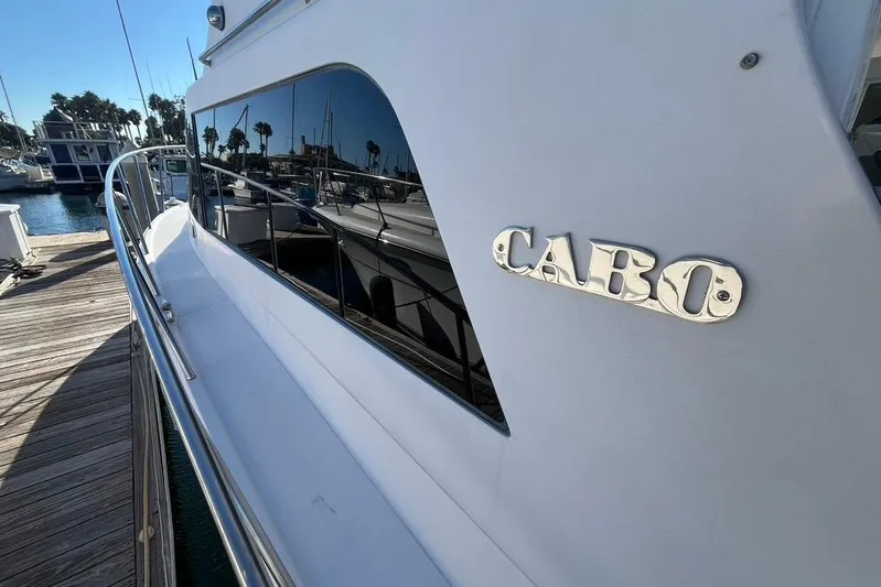 Assalt Weapon Yacht Photos Pics 2007 Cabo 35 Flybridge yacht docked, showcasing sleek design and reflective windows.