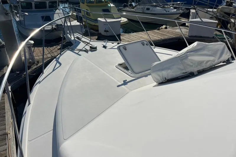 Assalt Weapon Yacht Photos Pics 2007 Cabo 35 Flybridge boat deck at marina, featuring hatch and railing.