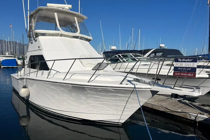 Assalt Weapon Yacht Photos Pics 2007 Cabo 35 Flybridge yacht docked, for sale, with clear blue sky background.