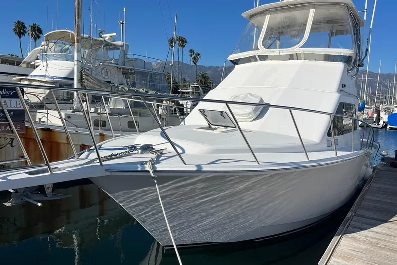 Assalt Weapon Yacht Photos Pics 2007 Cabo 35 Flybridge yacht docked at marina under clear blue sky.