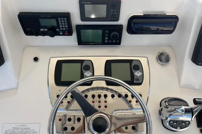 Assalt Weapon Yacht Photos Pics 2007 Cabo 35 Flybridge helm with navigation instruments and steering wheel.