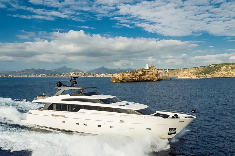 Musha Yacht Photos Pics Luxurious 2012 Sanlorenzo 579 yacht cruising near scenic coastline under blue skies.