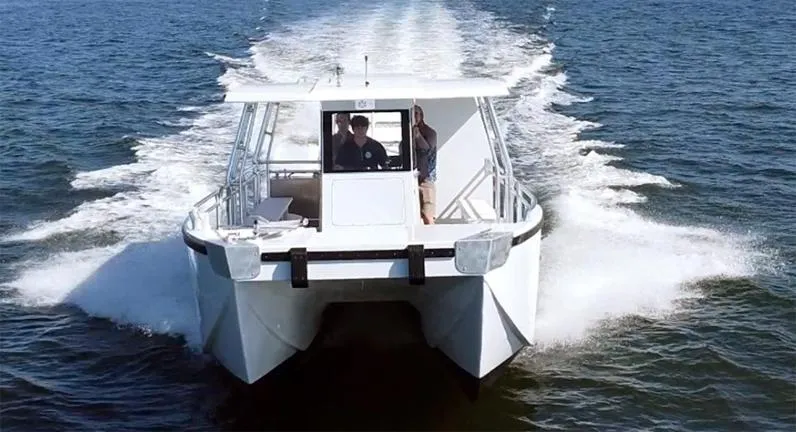  Yacht Photos Pics Custom 34 boat cruising on open water, 2025 model, front view.