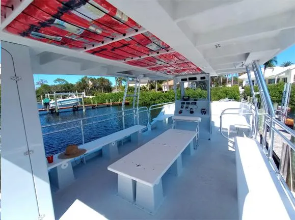  Yacht Photos Pics Spacious deck of a 2025 Custom 34 boat with seating and control panel.