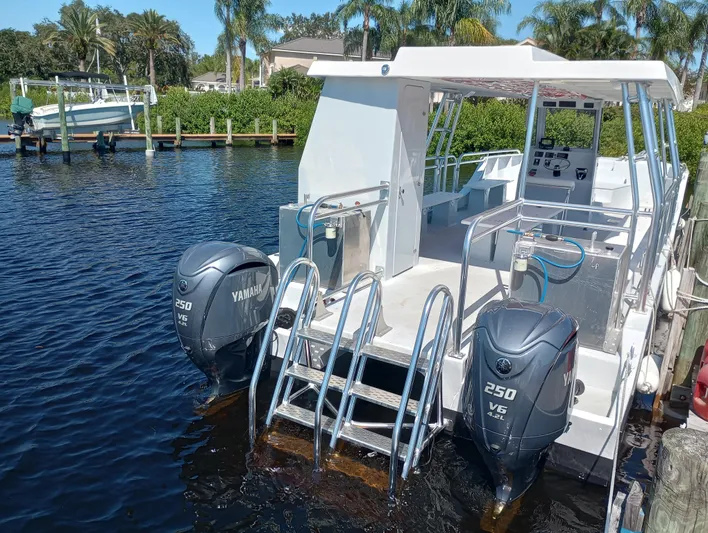  Yacht Photos Pics Custom 34 boat, 2025 model, with dual Yamaha 250 V6 engines docked by the water.