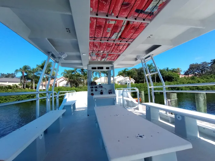  Yacht Photos Pics Open deck of a 2025 Custom 34 boat with benches and control panel.