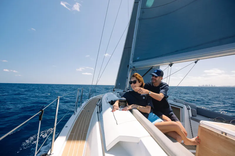 Yacht Photos Pics Couple sailing on a 2021 Jeanneau 51 yacht in open sea.
