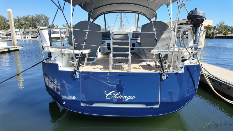  Yacht Photos Pics 2021 Jeanneau 51 yacht docked, rear view, blue hull, named "Chicago".