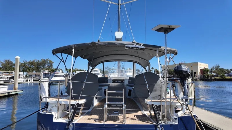 Yacht Photos Pics 2021 Jeanneau 51 yacht docked at marina under clear blue sky.