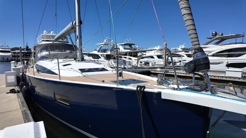  Yacht Photos Pics 2021 Jeanneau 51 yacht docked at marina, surrounded by other luxury boats.